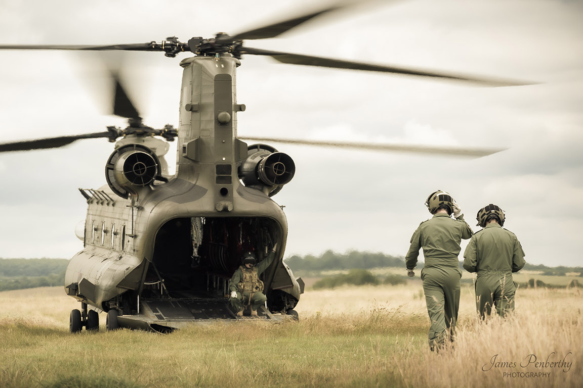 Image shows RAF aviators walking towards a Chinook helicopter with its loading bay open.